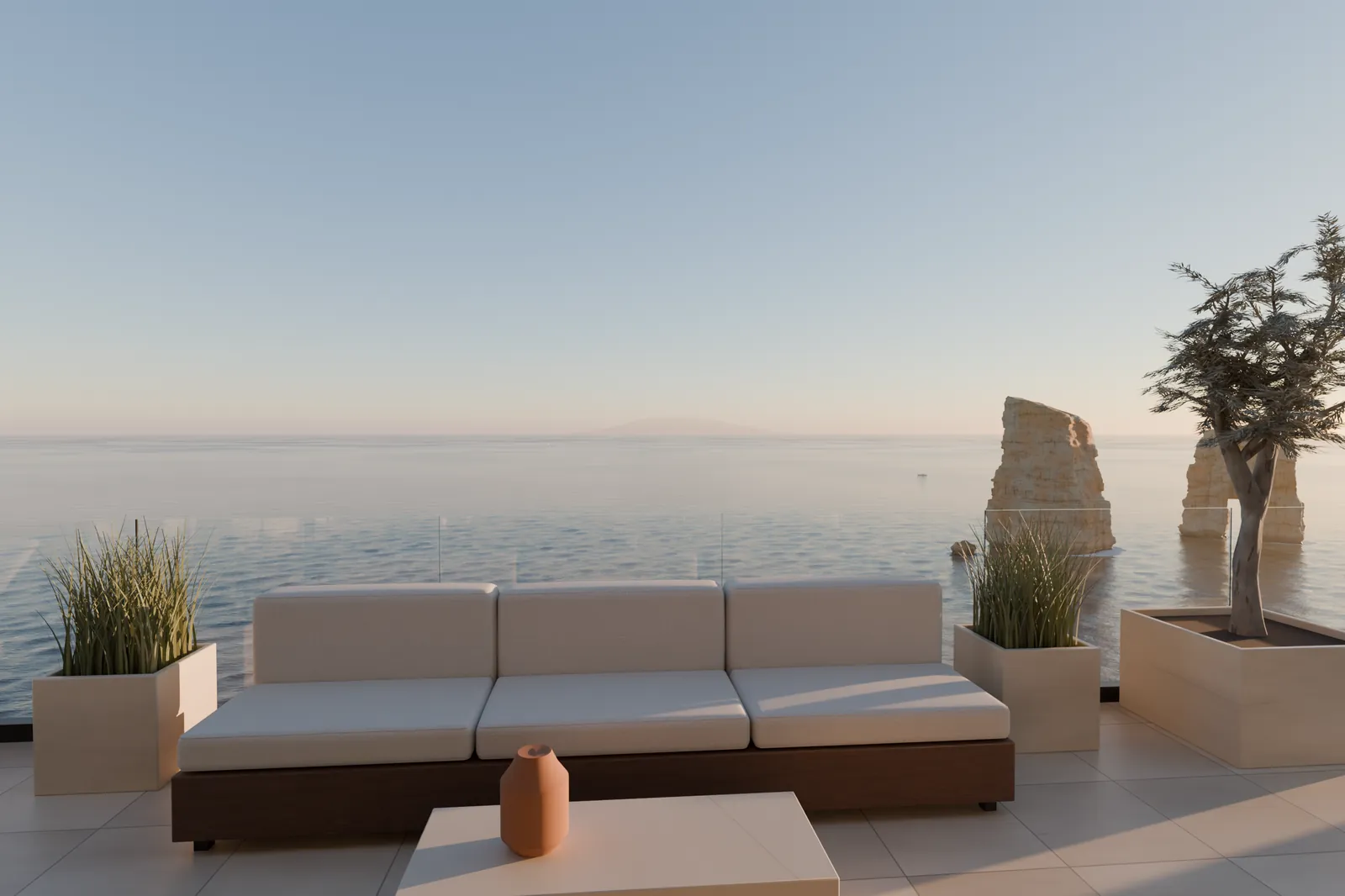 Terrace lounge at sunset: an outdoor sofa, grasses in planters, an olive tree and two sea stacks